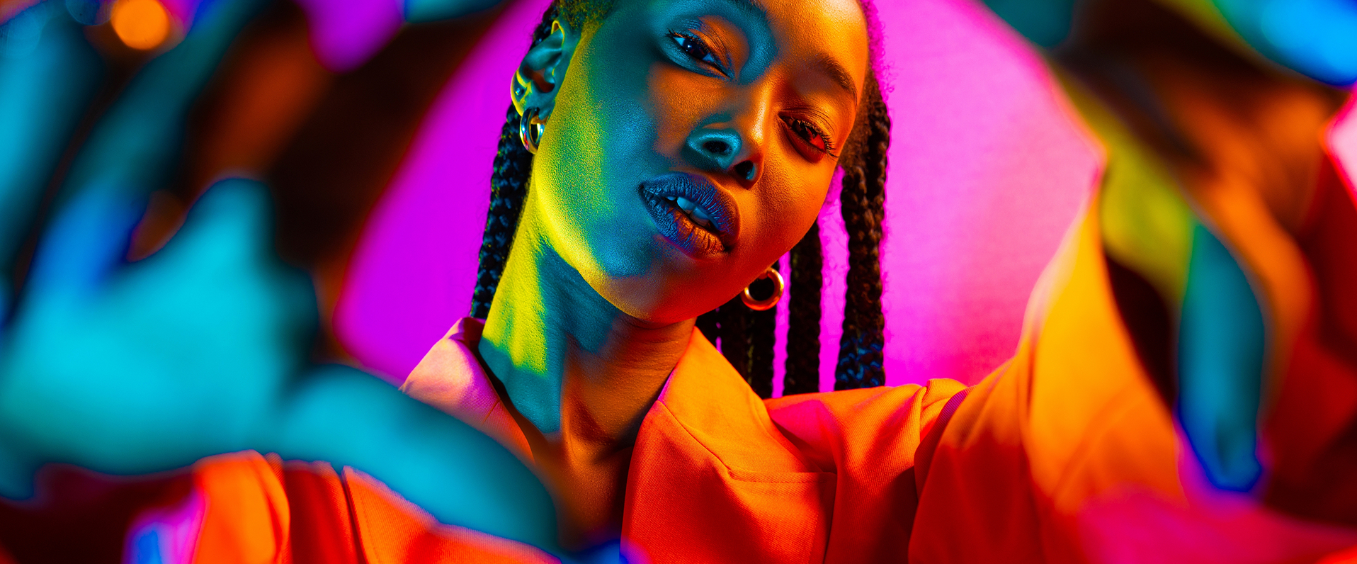 A woman with braids stands in front of a vibrant background, representing a youth-led podcast channel