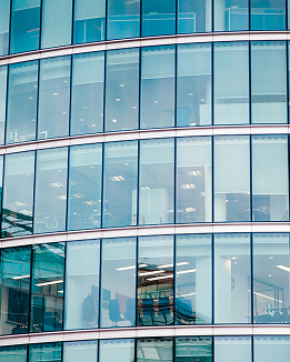 Modern building with a large window symbolising a trusted podcast space for professionals to learn from industry leaders