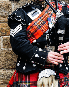A man wearing a kilt plays a bagpipe, representing a podcast dedicated to exploring bagpipe music